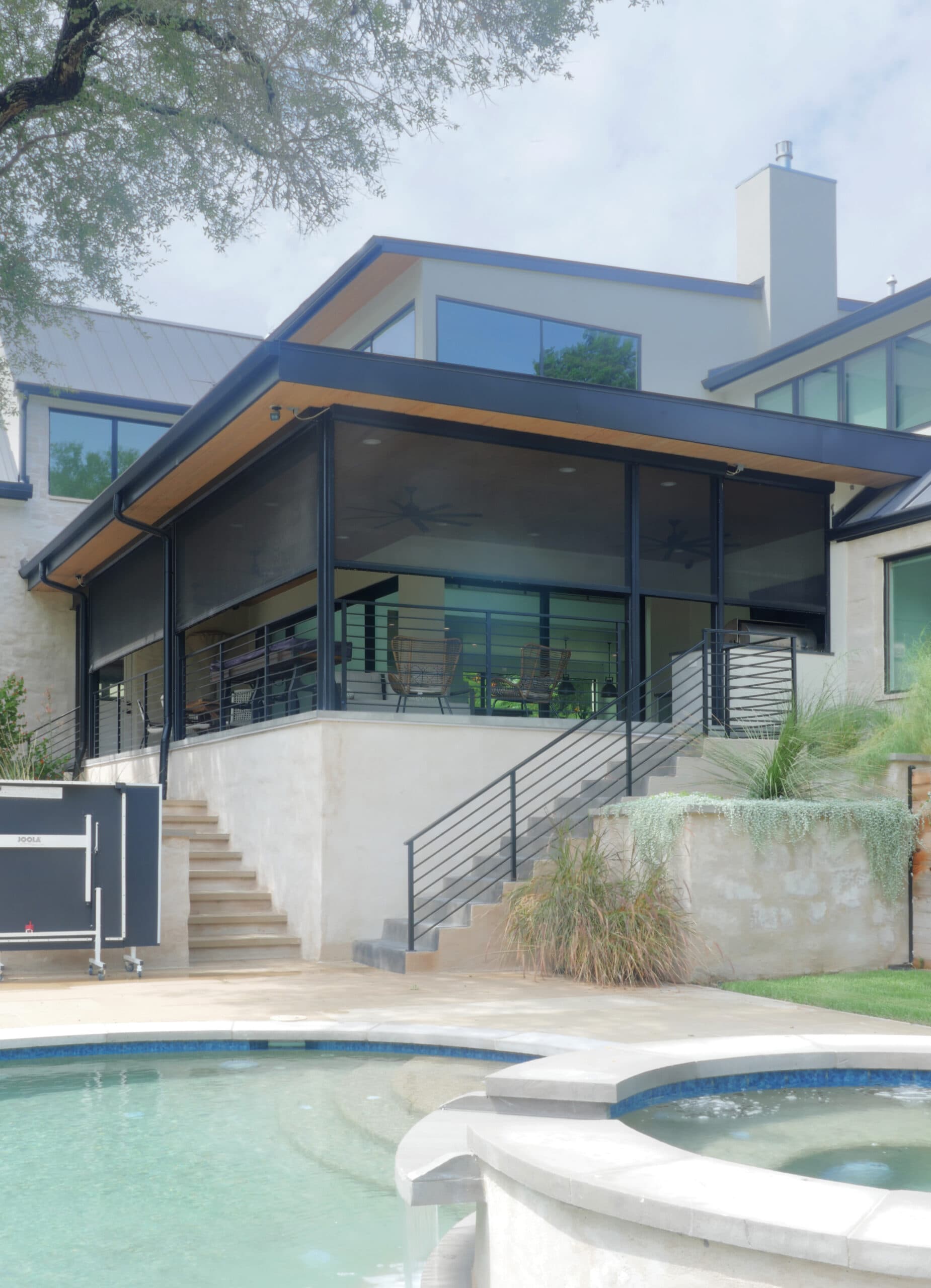 Motorized patio screens installed on brick patio with columns